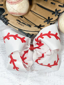 Baseball Texas Size Hair Bow. Red glitter "stitches" on white grosgrain ribbon bow.  Alligator clip at back.  Little Gift Nook.