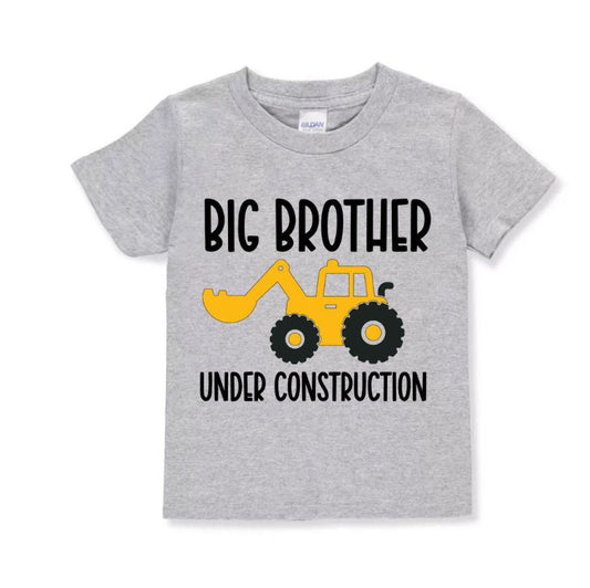 Big Brother Under Construction Tshirt - Heather gray short sleeve tshirt with yellow front loader and big brother under construction on front. Little Gift Nook