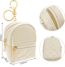 Load image into Gallery viewer, Cream quilted mini backpack keychain with 2 pockets that open with gold zippers and gold ring, chain, and lobster clip. Measures 3.94 inches tall.  Little Gift Nook.