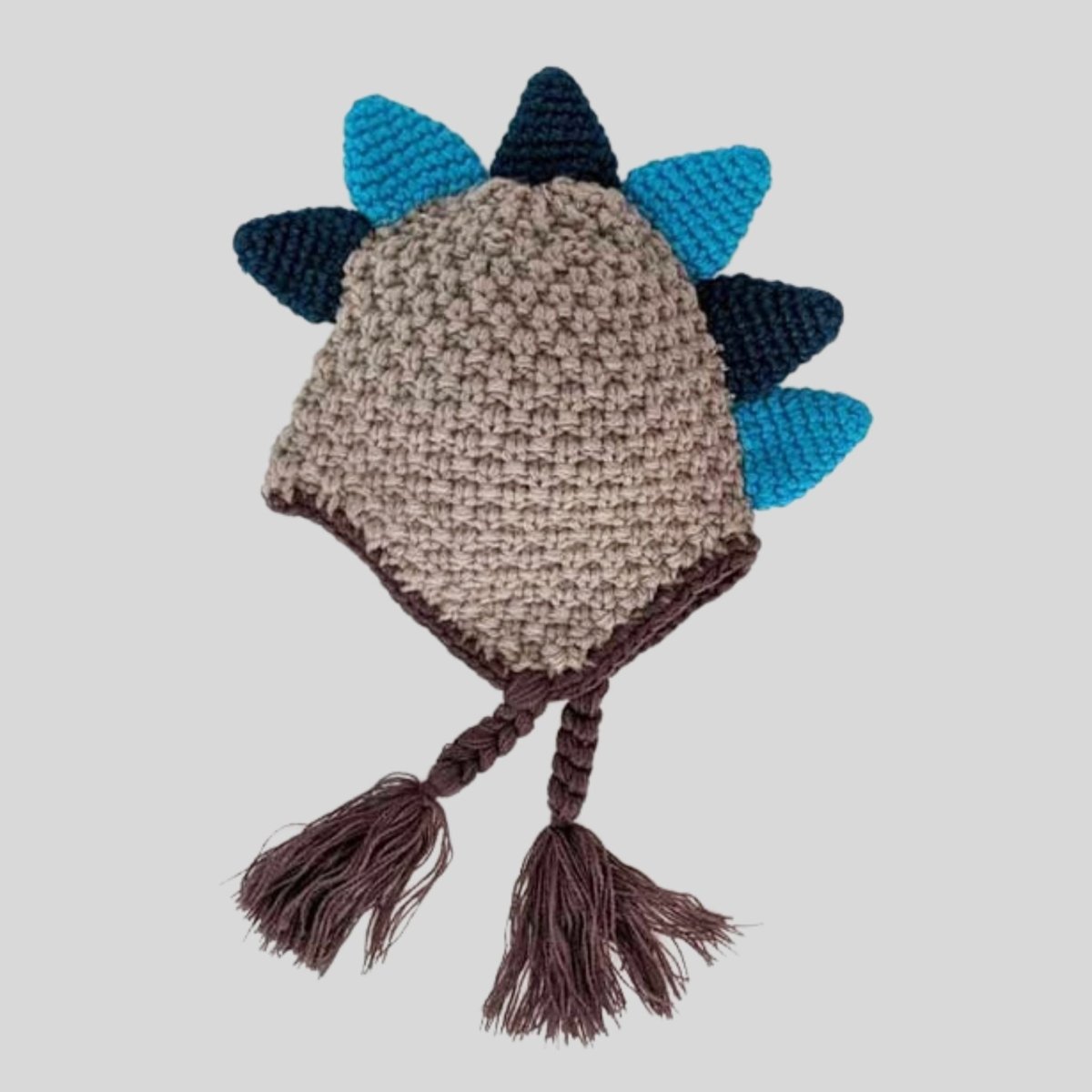 Dinosaur knit Beanie Hat for Baby. Gray teal green knit beanie hat with small braided tassels and dino plates or spikes at top.  - Little Gift Nook