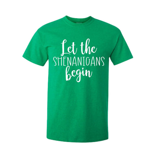 Irish Green short sleeved unisex tshirt with Let the Shenanigans begin in white lettering on front. Little Gift Nook.