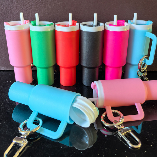 Mini Stanley inspired Tumbler Keychain. Lid screws off. Holds chapstick or small items. Multiple Colors. Metal keyring and lobster clip. 7 total colors. Little Gift Nook.