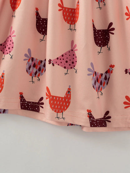 Close up of pink chicken hen print twirl dress.  Little Gift Nook. 