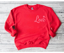 Load image into Gallery viewer, Red Pink LOVE Crewneck Sweatshirt. Red fleece lined unisex crewneck sweatshirt with pink LOVE and hearts at top left. Little Gift Nook.