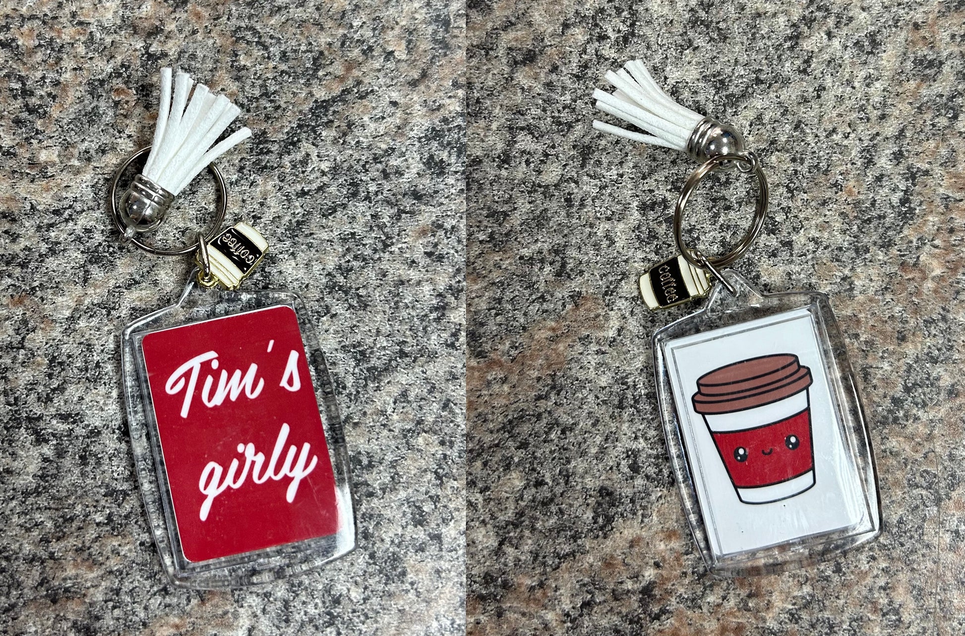 Tim's Girly Coffee Keychain. 2 inch tall rectangular clear double image keychain. One side is red with Tim's girly in white lettering. Other side is white with little red coffee cup with face. Comes with white tassel and metal coffee cup charm.- Little Gift Nook