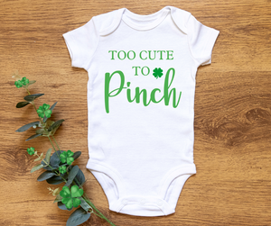 Too Cute to Pinch St. Patty's Bodysuit. White Short sleeve bodysuit with green lettering on front and little clover. St. Patty's Day. Little Gift Nook.