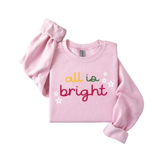 Pink folded all is bright  in yellow, green, and pink lettering with white stars crewneck sweatshirt sitting on white background. 