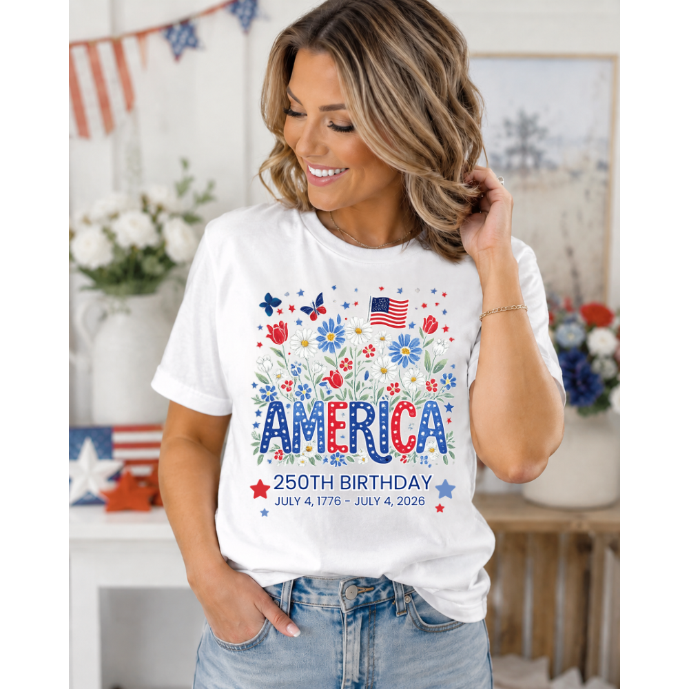 Woman wearing a white t-shirt with 'America 250th Birthday' floral design in a decorated room.