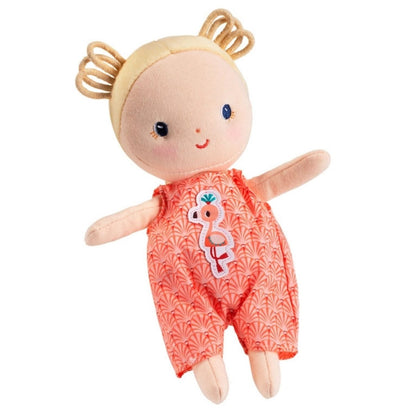 Janod Anais soft blond baby doll in pink flamingo romper sitting on white background. 