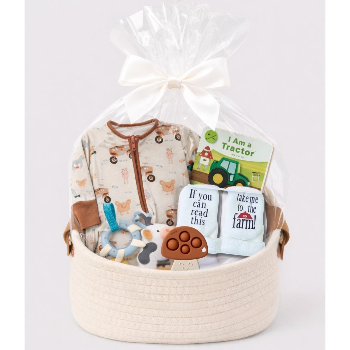 Baby farm theme gift bundle in a basket with cellophane and bow. Little Gift Nook