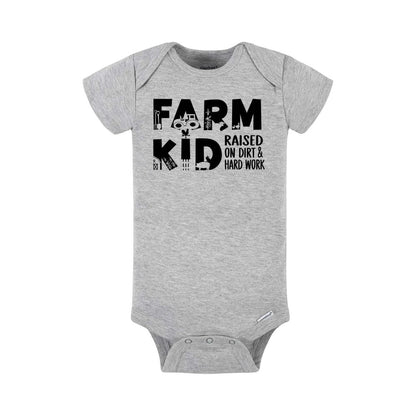 Heather gray "Farm Kid" baby onesie with farm theme icons in each letter and "raised on dirt & hard work" text on front laying on a white background.
