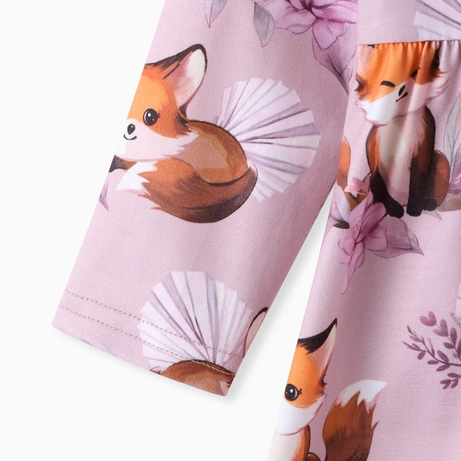 Close up of lavender and orange fox print baby girl top sleeve on white background. Little Gift Nook