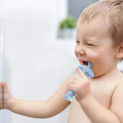 baby using and chewing on ToothieBrush Baby & Toddler Toothbrush in Blue.