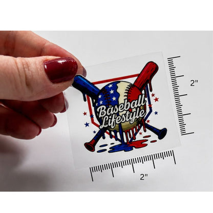 Sticker with 'Baseball Lifestyle' design held by a hand, with measurement guides on a white background.