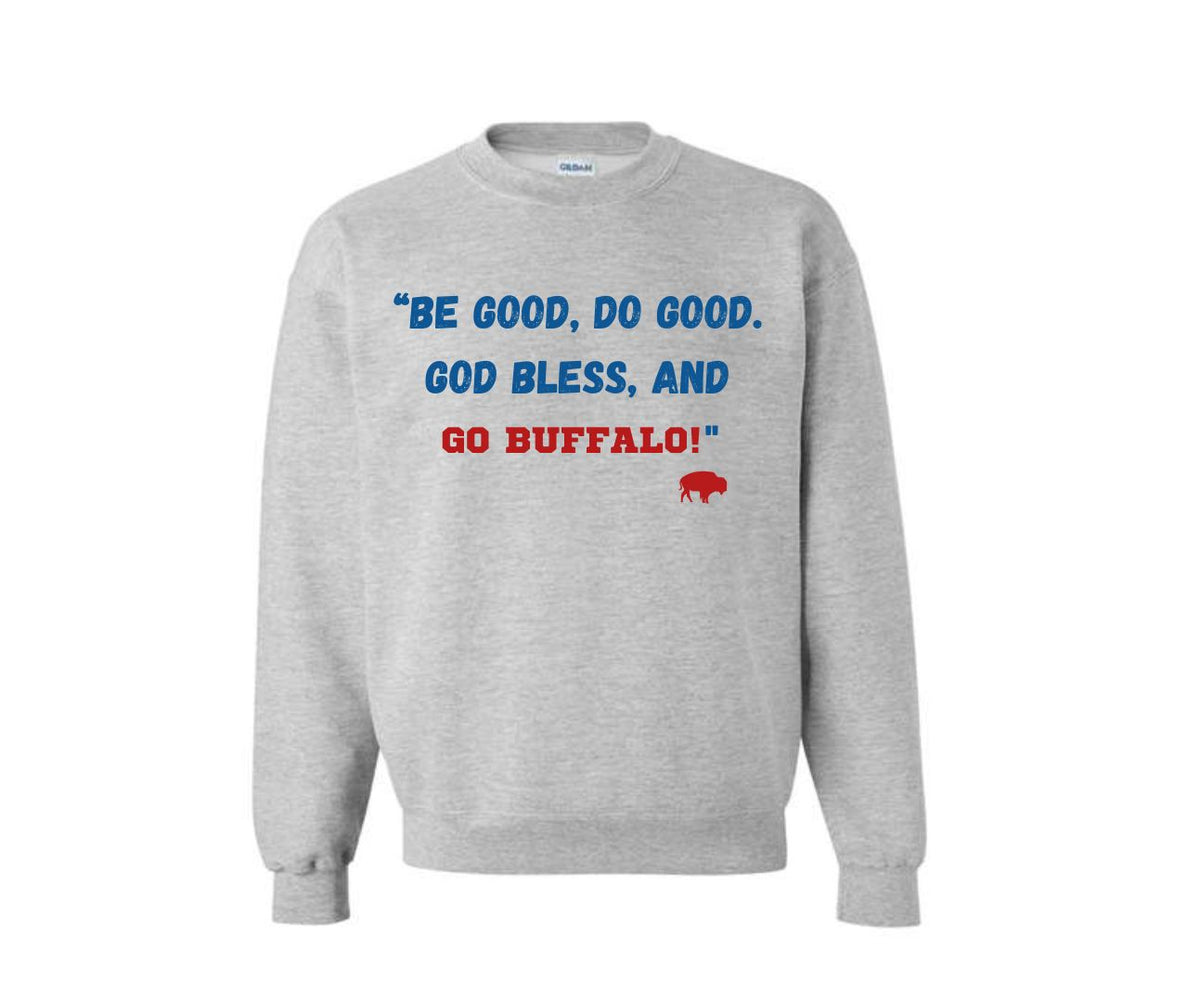 A light heather gray crewneck sweatshirt featuring the political slogan 'BE GOOD, DO GOOD. GOD BLESS, AND GO BUFFALO!' printed on the chest in blue, red, and white, with a small red buffalo graphic below.