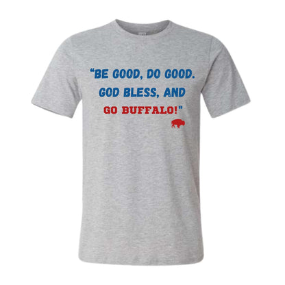 A heather gray short-sleeve t-shirt with a graphic text print on the chest reading 'BE GOOD, DO GOOD. GOD BLESS, AND GO BUFFALO!' in blue and red lettering, accompanied by a small red buffalo silhouette.