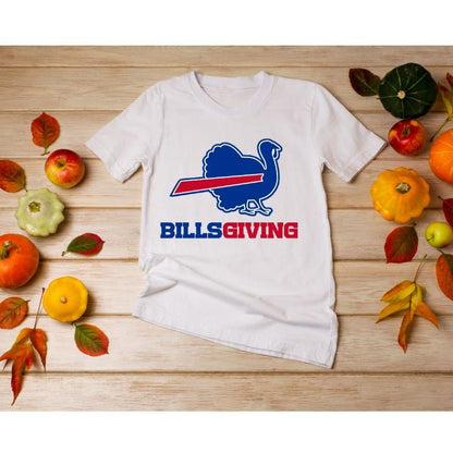 White BILLSGIVING Blue red turkey Buffalo football Thanksgiving tshirt laying on wood background with pumpkins. 