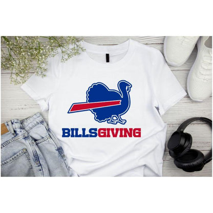 White BILLSGIVING Blue red turkey Buffalo football Thanksgiving tshirt laying on light wood background with jeans, shoes, and headphones. Little Gift Nook 