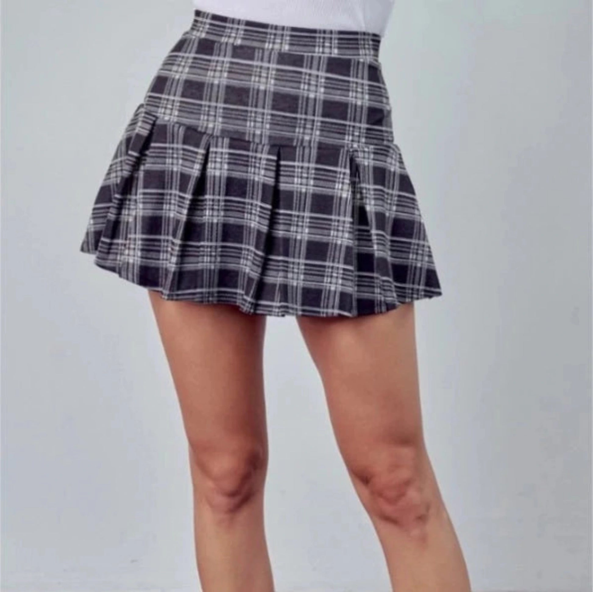 Woman's Black Plaid Print Pleated Skirt. Close up of mini skirt with chunky pleats. - Little Gift Nook