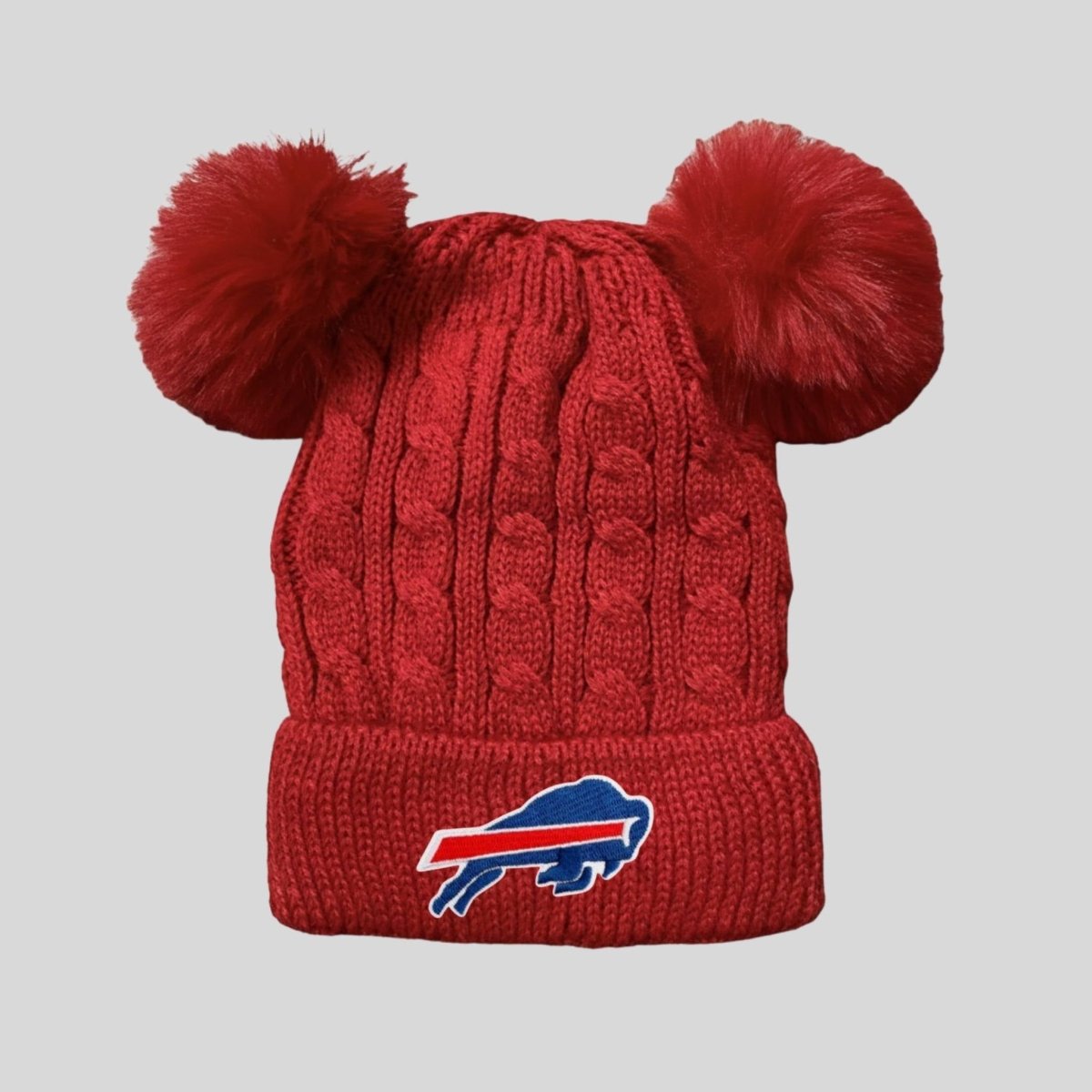 Red knit double pom pom Buffalo Football baby toddler winter hat on gray background. 