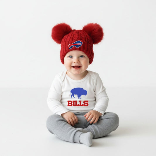 Buffalo football red double pom baby toddler winter hat on baby sitting on white background. Little Gift Nook