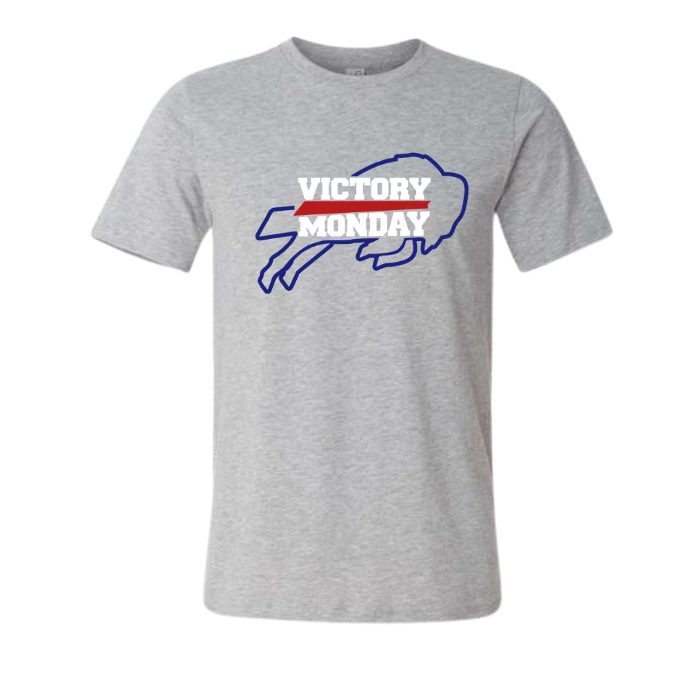 A heather gray short-sleeve crewneck t-shirt featuring a 'VICTORY MONDAY' buffalo graphic on the chest in blue, white, and red.
