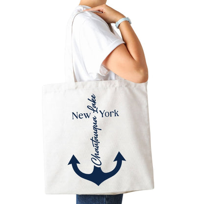 Woman holding white canvas tote bag with navy anchor Chautauqua Lake - Little Gift Nook