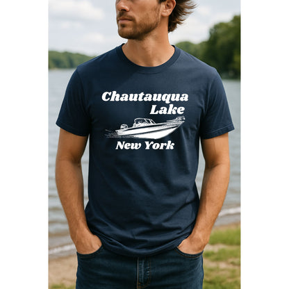 Man wearing navy white "Chautauqua Lake New York" boat tshirt standing in front of lake. 
