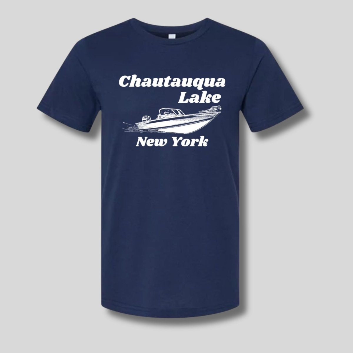 Navy tshirt with white sketched boat and "Chautauqua Lake New York" on front sitting on light gray background.