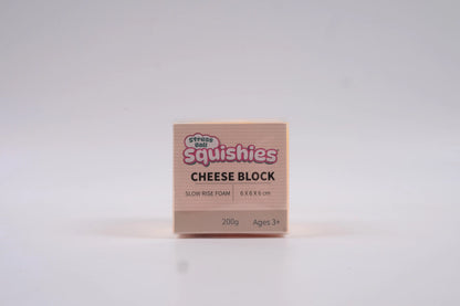 Squishies Cheese block squishy slow rise foam sensory fidget toy in box on a white background.
