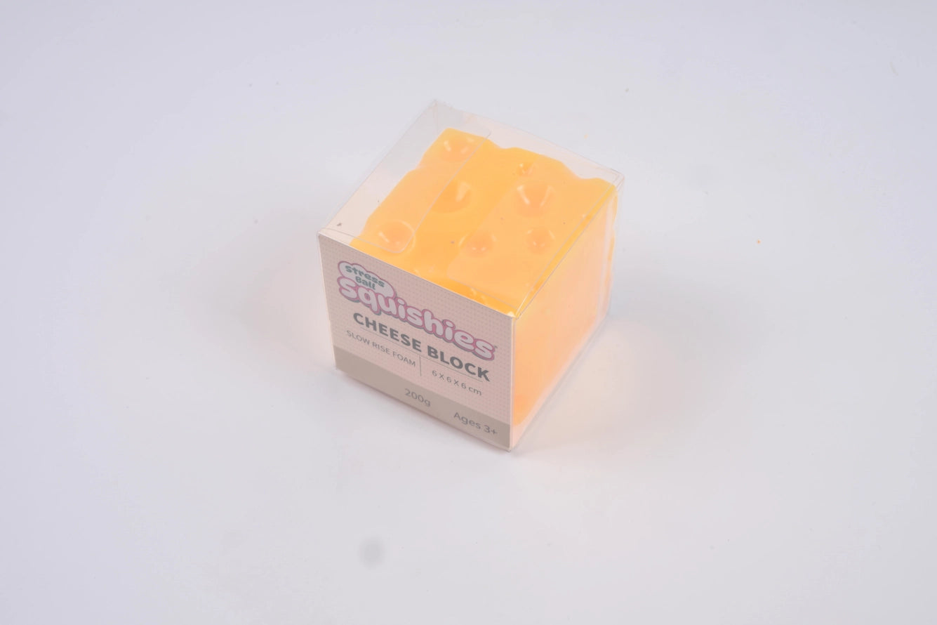 Squishies cheese block squishy sensory fidget toy slow rise fidget in clear box packaging sitting on white background.