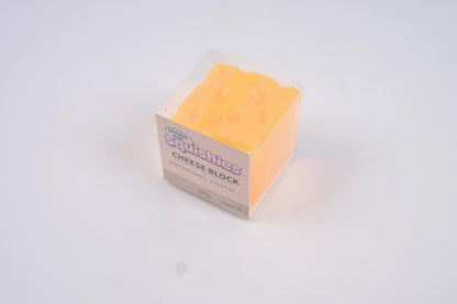Squishies cheese block squishy sensory fidget toy slow rise fidget in clear box packaging sitting on white background.