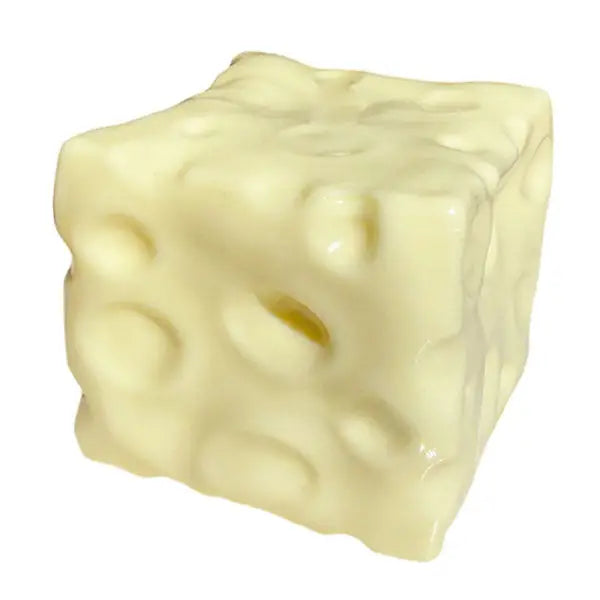 Cheese block squishy sensory fidget toy sitting on white background.