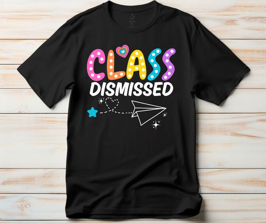 Black Class dismissed paper airplane tshirt on a light wood background. Little Gift Nook