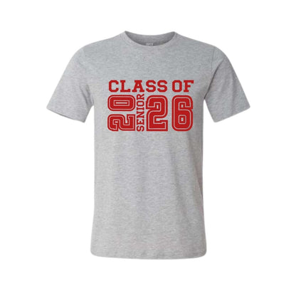 Gray t-shirt with red Class of 2026 senior text on front sitting on white background. Little Gift Nook