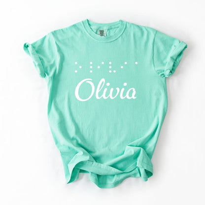 Mint t-shirt with custom name "Olivia" on front and name in Braille letters above in puffy raised vinyl.