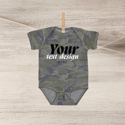 Blank green navy camo baby onesie personalized custom onesie hanging on clothespin n wood background.