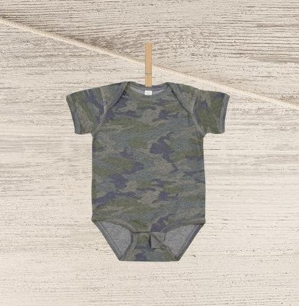 Blank green navy camo baby onesie personalized custom onesie hanging on clothespin n wood background.
