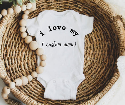 White personalized custom baby ones "I love my" custom name in wicker basket with beads. 