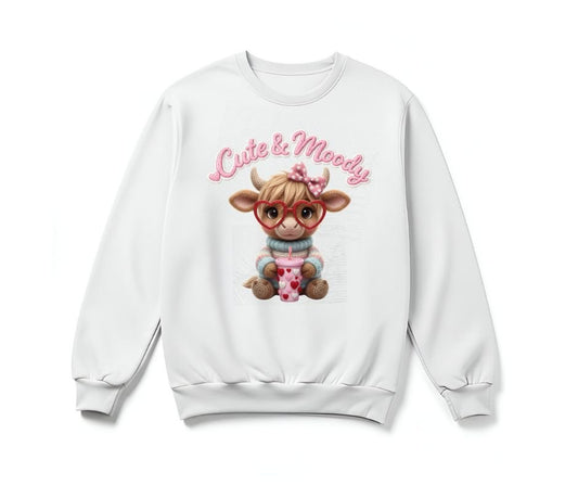 White sweatshirt with  "cute & moody" crochet style flat graphic cow in heart glasses on front sitting on white background.