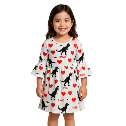 Dinosaur Print Heart Dress. Little Giftl wearing White bell sleeve dress with black trex dinos earting red hearts. - Little Gift Nook