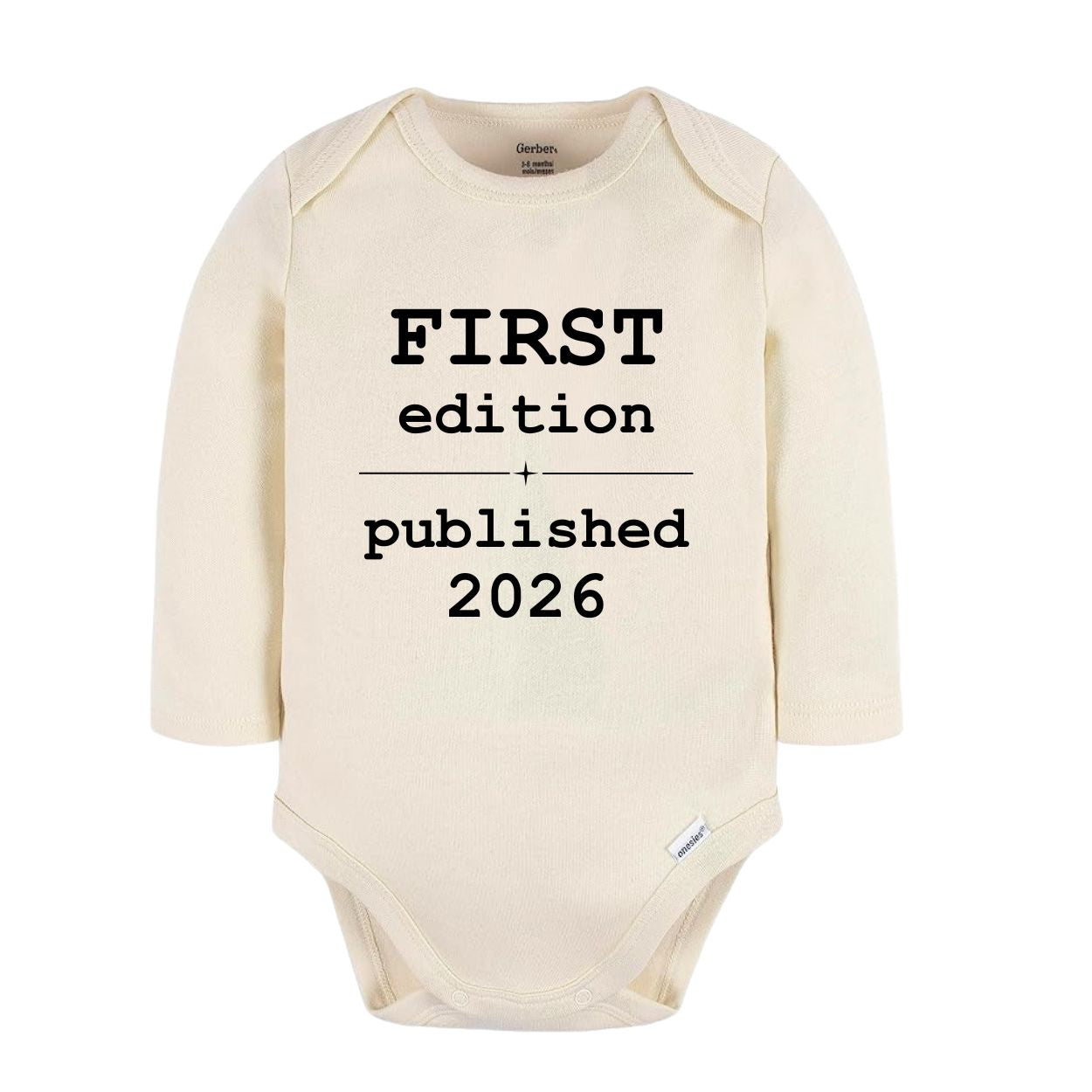 A cream-colored long-sleeve baby bodysuit with black printed text reading 'FIRST edition published 2026' on the front, shown against a plain white background.