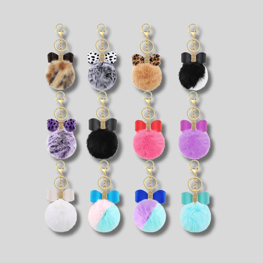 Fuzzy pom pom faux leather bow gem keychain with lobster clip. 12 different colors and patterns. Little Gift Nook.