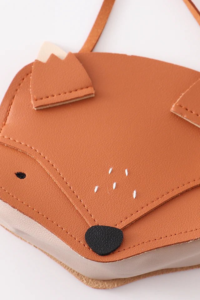 faux leather orange fox face kids purse close up on gray background.