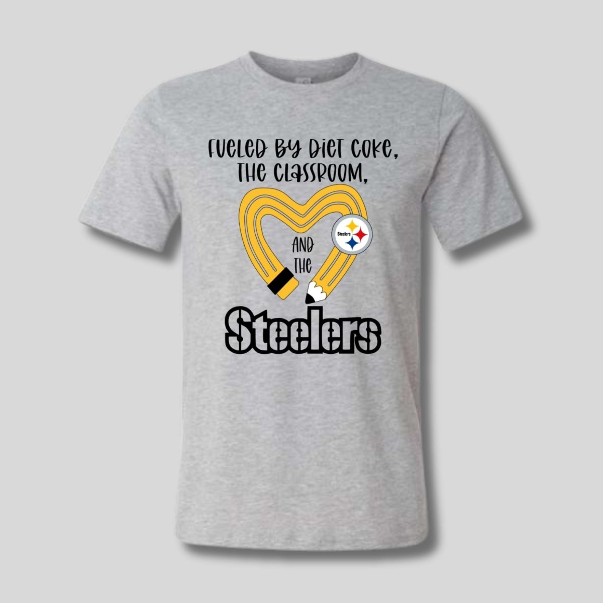 gray tshirt with yellow black pencil heart design and "fueled by diet coke, the classroom, and the Steelers" image on front. Little Gift Nook