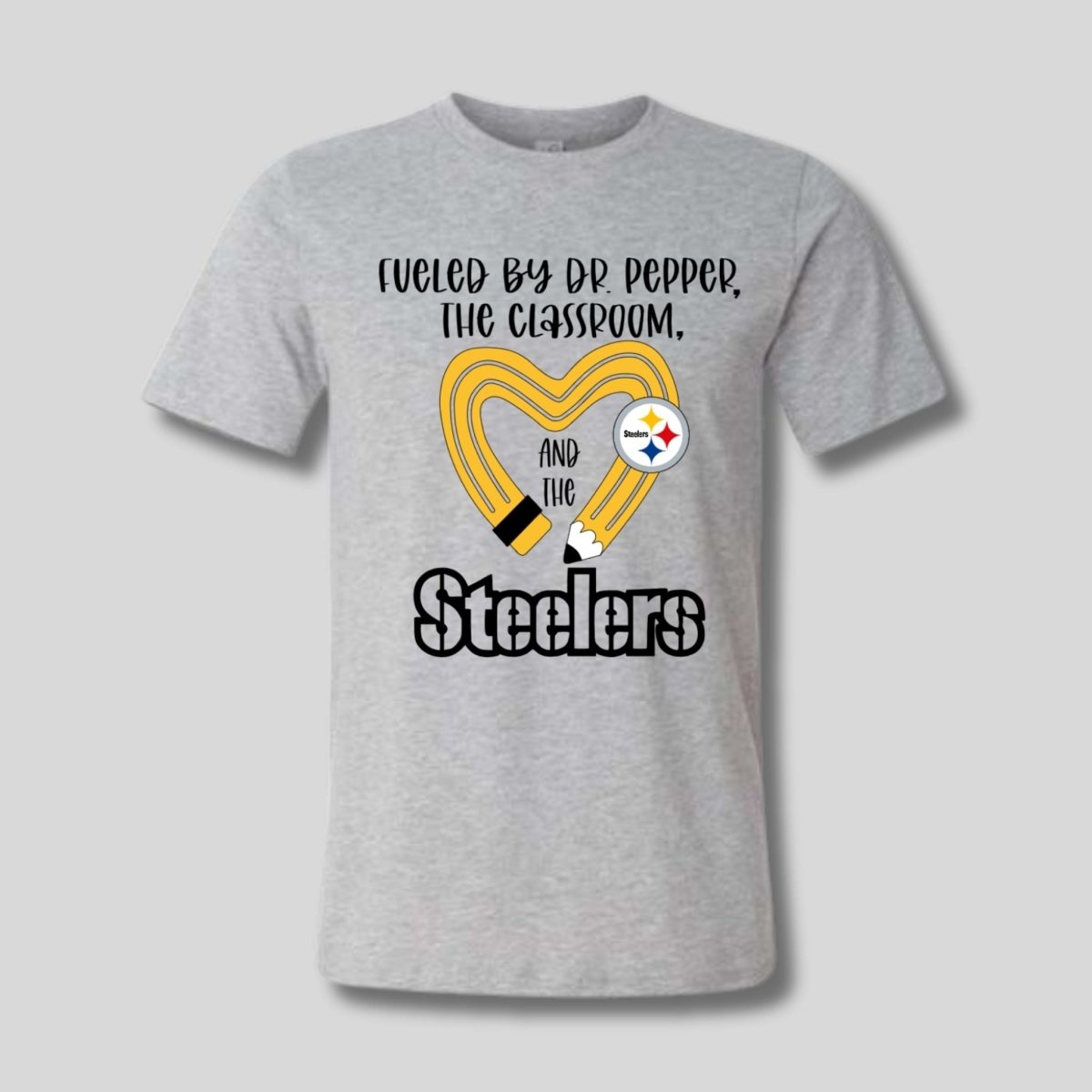gray tshirt with yellow black pencil heart design and "fueled by dr pepper, the classroom, and the Steelers" image on front. Little Gift Nook