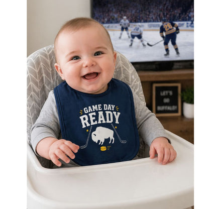 Baby wearing a bib with 'Game Day Ready' text and buffalo hockey graphic sitting in a high chair with a hockey-themed background.