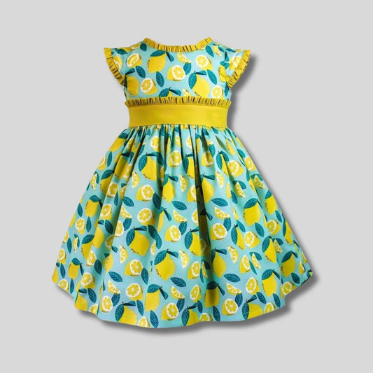 Girl's yellow and teal lemon print ruffle dress on gray background. Little Gift Nook