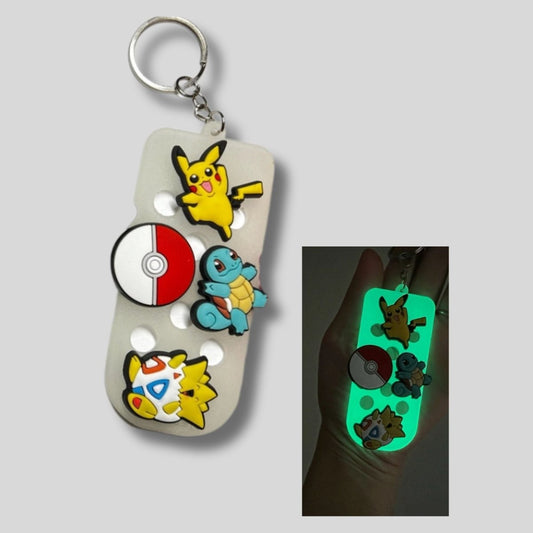 Clear 3.5" glow in the dark shoe charm keychain with Pokemon charms on it. Little Git Nook 