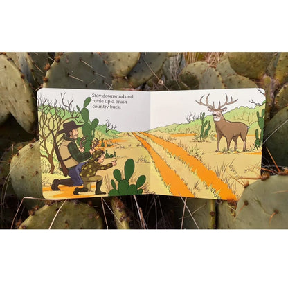 Illustrated pages of "Good Luck Hunters" book with a man, boy, and deer on a desert landscape, surrounded by cacti. 